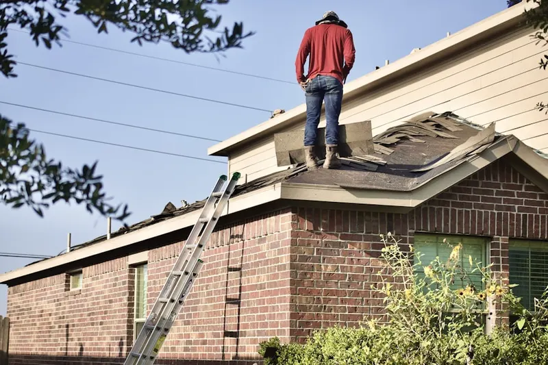 Professional roofer working on a residential roof in Martins Ferry